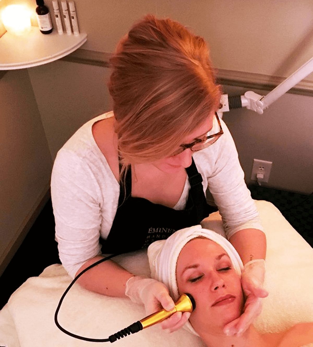 Esthetician performing a facial treatment at Wellness Origin Spa