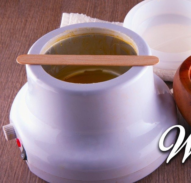 Wax warmer and supplies set up for a waxing service